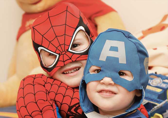 two boys dressed as superheroes