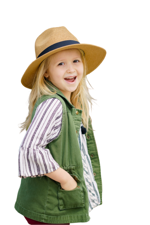 girl in a hat stands and smiles