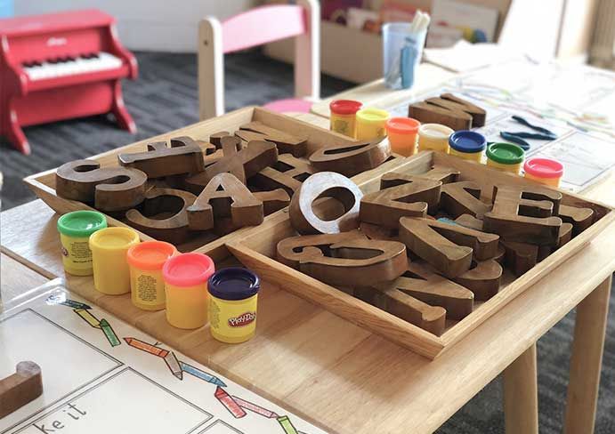 wooden letters arranged on a children's play table