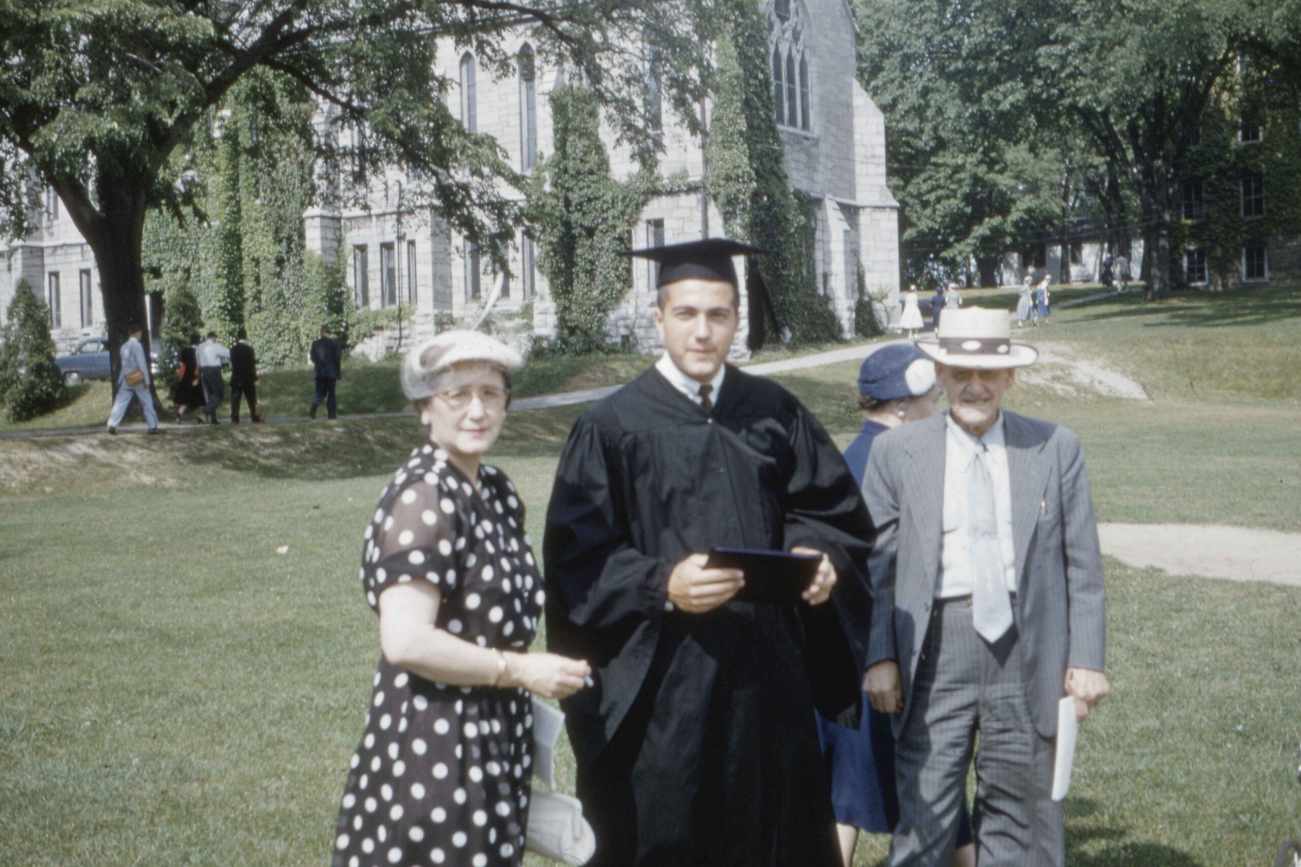 student with his parents on graduation day outside the university in 1962